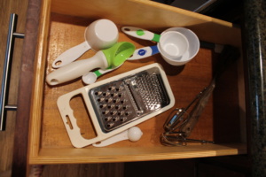 Measuring cups, mixer, grater and ice cream scoop.